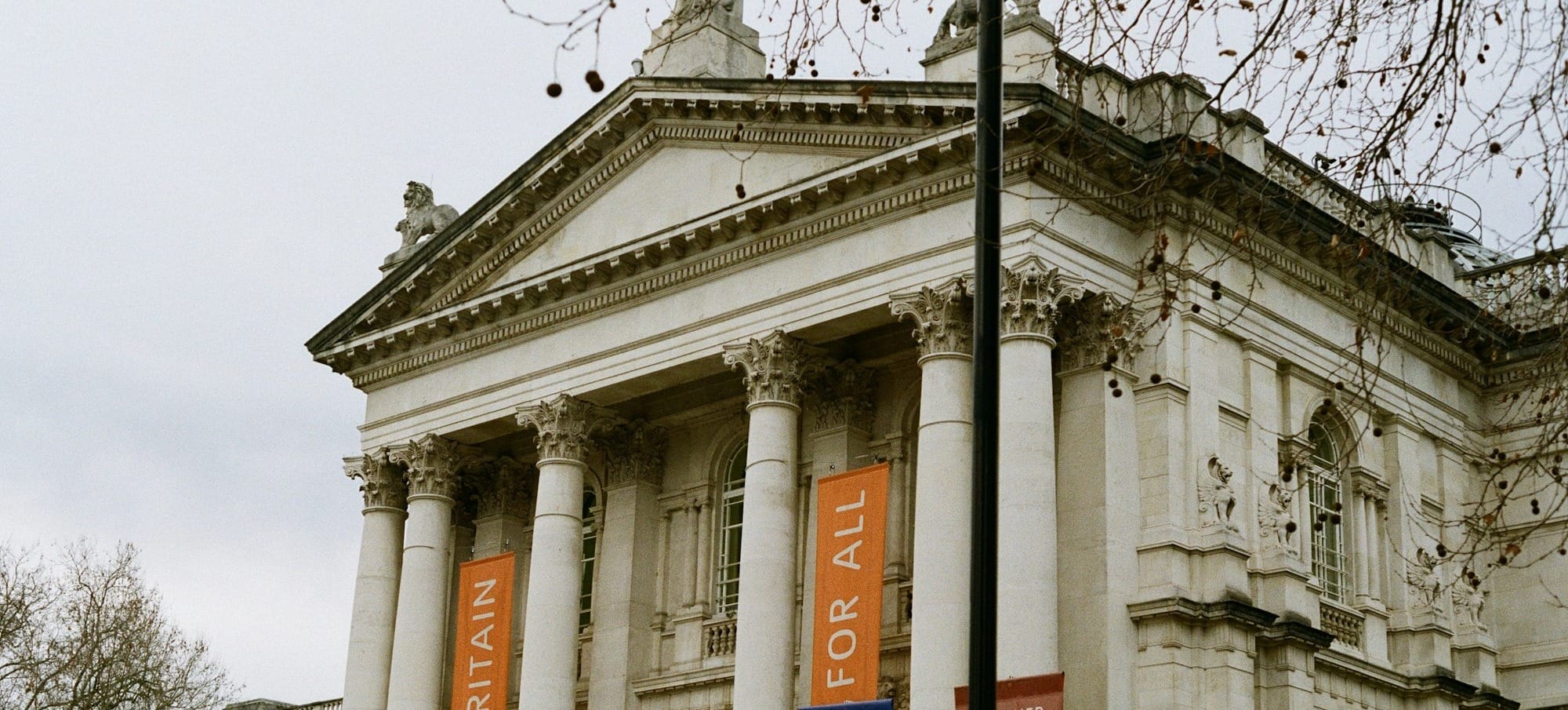 a large building with columns and banners on it