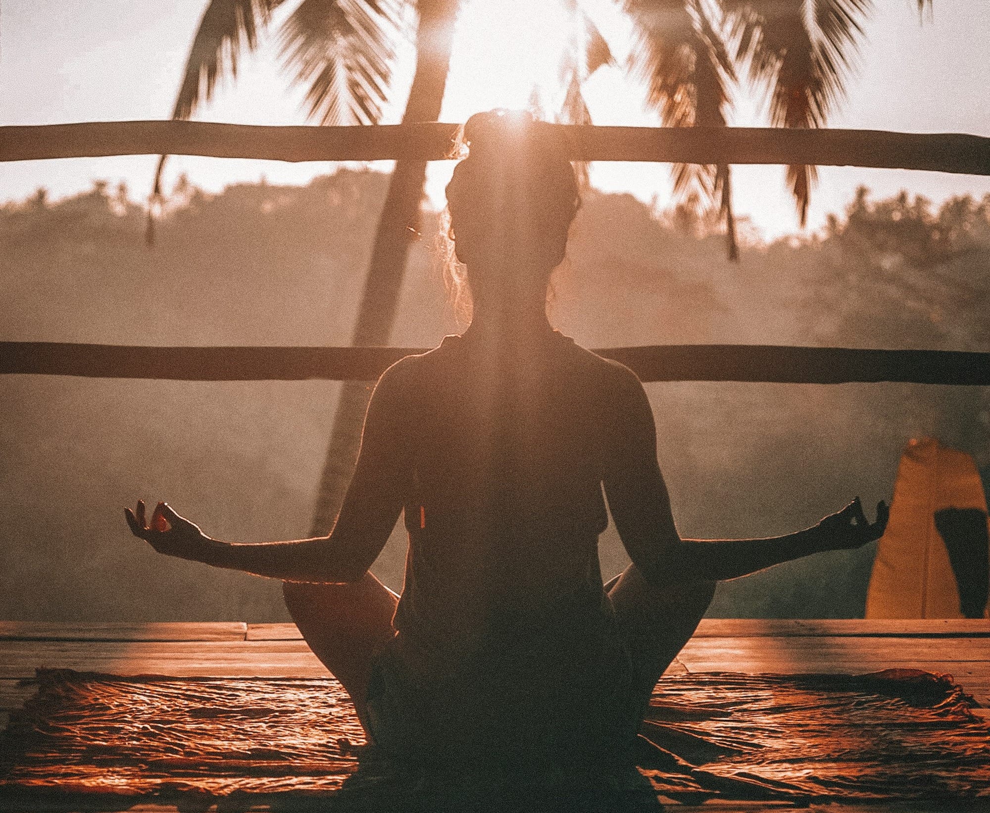 woman doing yoga meditation on brown parquet flooring